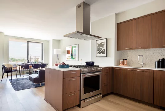 Custom walnut kitchen cabinetry, polished quartz countertops and Calacatta marble backsplash.