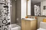 Luxurious tiled baths feature custom wood cabinetry and oversized custom-designed medicine cabinets