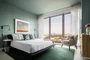 Spacious bedrooms include floor-to-ceiling windows.