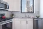 The gourmet kitchen at One Union Square South features Euro-style cabinetry and granite countertops.