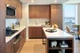 White quartz kitchen counter with a full-height Carrara marble tile backsplash