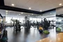 A state-of-the art Health and Fitness Center features cardio and strength equipment and lots of natural light streaming through a wall of windows.