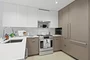 Open kitchen with custom cabinetry, premium stainless steel, gas appliances and flexible dining space