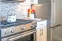 The gourmet kitchen at One Union Square South features Euro-style cabinetry and granite countertops.