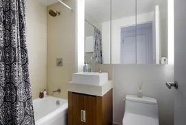 Bathrooms feature golden sandstone tile with arctic white corian vessel sinks.