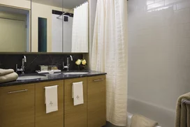 The designer baths at Riverwalk Crossing feature white ceramic tiled bathrooms with Grigio Alfoni marble vanity tops and accents.