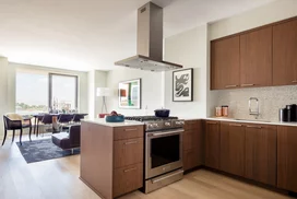 Custom walnut kitchen cabinetry, polished quartz countertops and Calacatta marble backsplash.