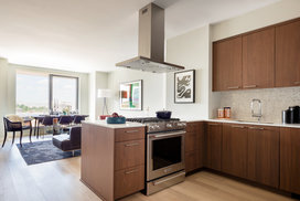 Custom walnut kitchen cabinetry, polished quartz countertops and Calacatta marble backsplash.