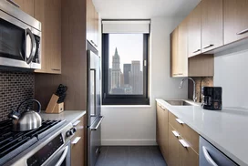 Tribeca Tower features gourmet kitchens with full-sized stainless steel appliances, custom wood cabinetry and white stone countertops. 