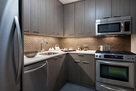 Tribeca Tower features gourmet kitchens with full-sized stainless steel appliances, custom wood cabinetry and white stone countertops. 