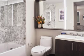 Inspired baths include a marble tub surround and glass enclosed shower, custom vanity and medicine cabinet.