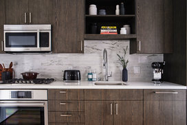 Gourmet kitchens feature gas cooktops and Bosch appliances with quartz counters and a marble backsplash.