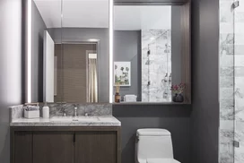 Luxe bathrooms include grey-oak vanities with marble counters and custom medicine cabinets.