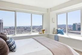 Large windows offer light-filled living with spectacular city views