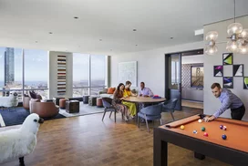 Media and game room with custom billiards table, TV, and bar