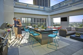 Rooftop terrace with dining tables and BBQ grills.