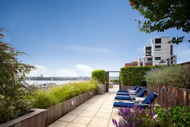 Perfectly planned landscaping on the rooftop terrace offers the ideal location to take in sweeping views of the Hudson River.