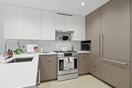 Open kitchen with custom cabinetry, premium stainless steel, gas appliances and flexible dining space