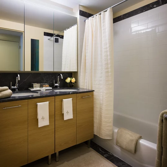 Custom bathrooms with Grigio Alfoni marble vanity tops and accents