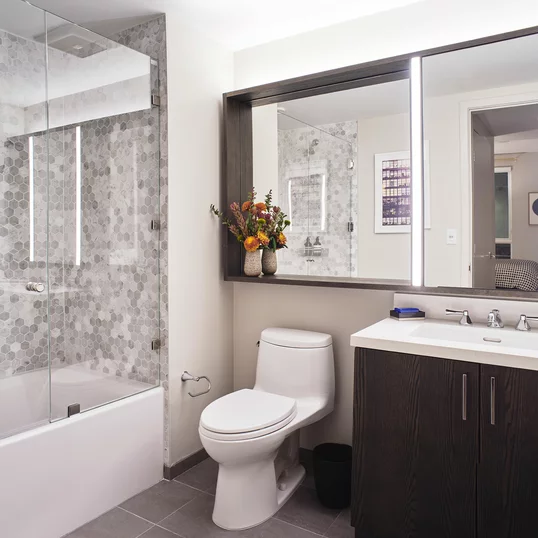 Inspired baths include a marble tub surround and glass enclosed shower, custom vanity and medicine cabinet.