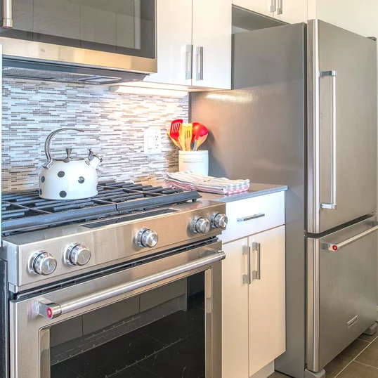 The gourmet kitchen at One Union Square South features Euro-style cabinetry and granite countertops.